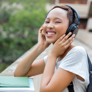 african female university student listening to music