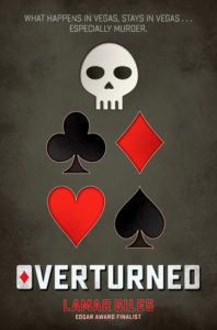 Overturned cover image: black background graphic drawing of skull and suits on playing cards