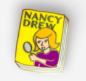Nancy Drew pin: enamel pin shaped like a book with yellow cover and blonde girl with magnifying glass