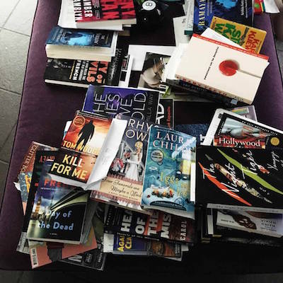 pile of books on purple lounge chair