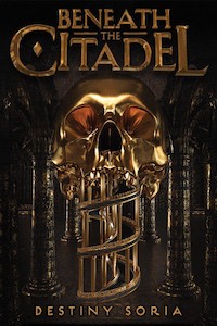 a golden skull opens its mouth, which becomes a winding staircase. the skull is set amongst tall pillars on a very dark background.