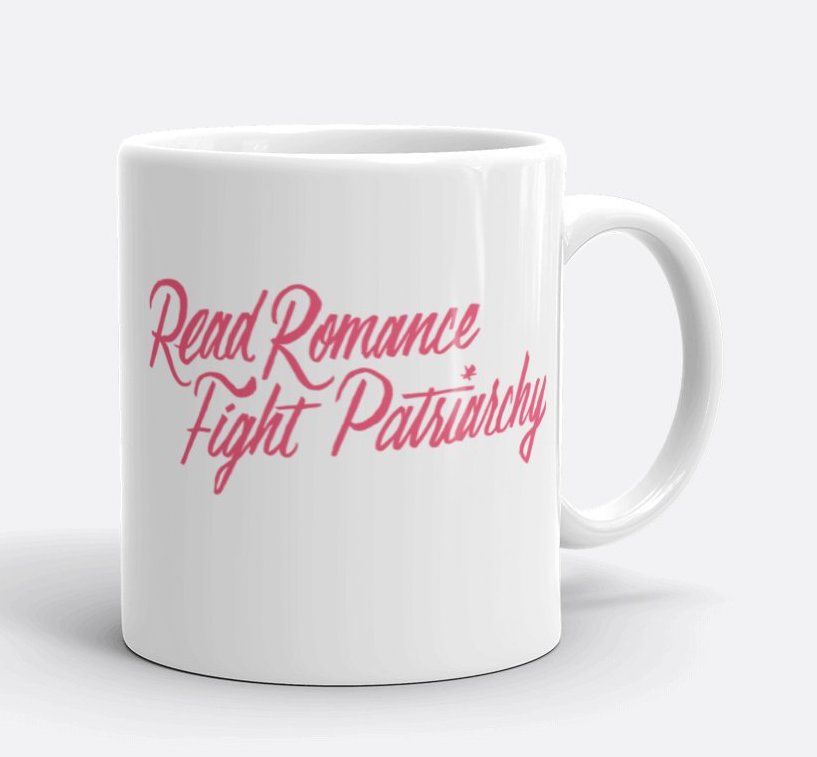 photo of white mug with pink letters that says "Read Romance, Fight Patriarchy"
