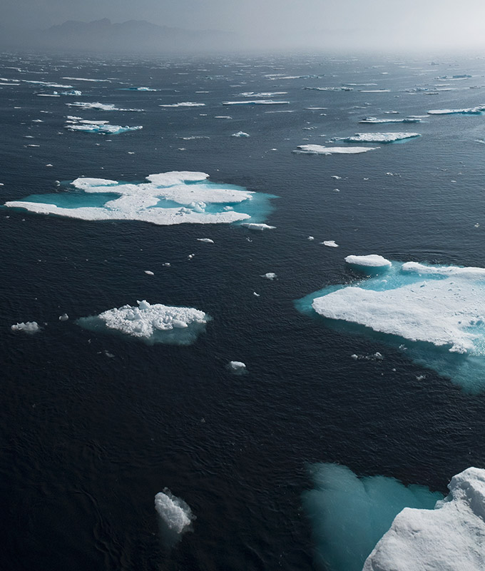 a photo of ice floes on a very blue sea