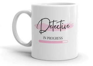 white mug that says Detective in progress