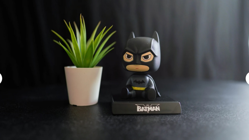 A small Batman figurine sits and glares from a desk top.