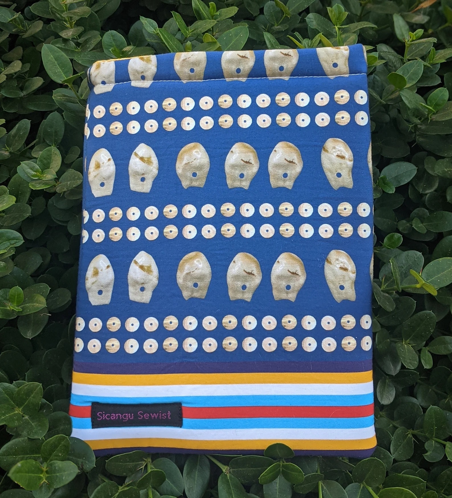 A photo of a blue book sleeve features animal teeth