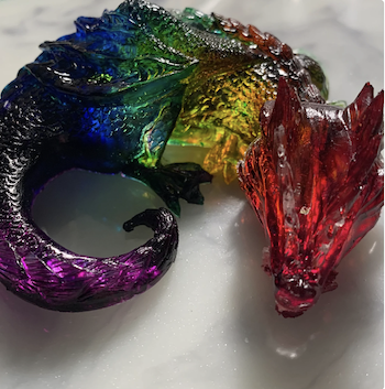 a photo of a rainbow resin dragon
