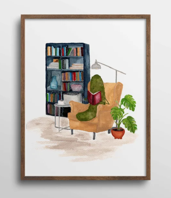 watercolor painting of a green pickle sitting in a chair in front of a bookshelf