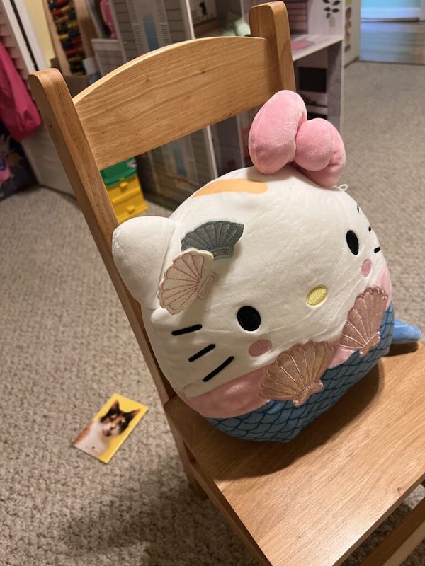 hello kitty pillow on a wooden chair