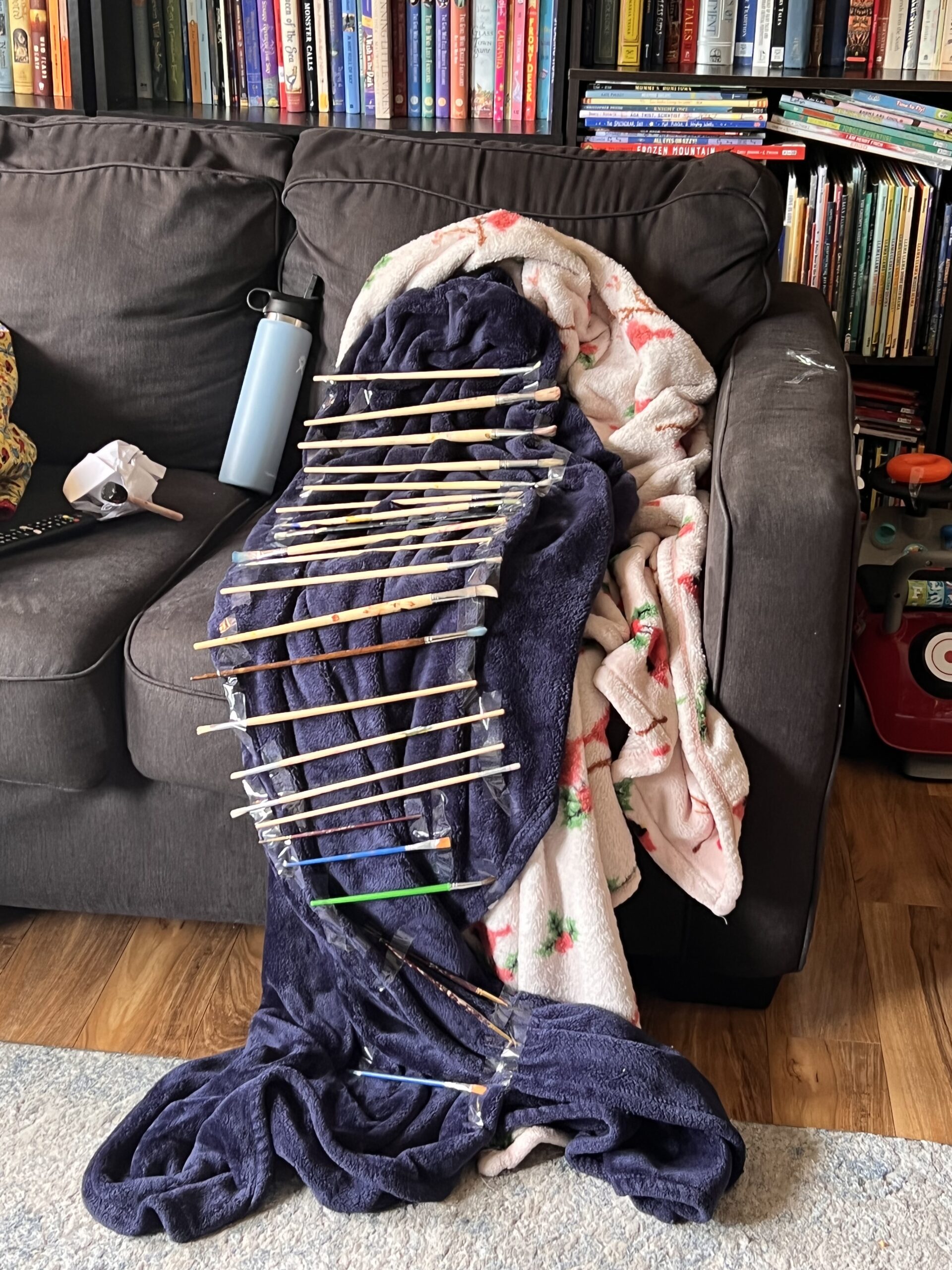 a ladder made out of paintbrushes and a blanket