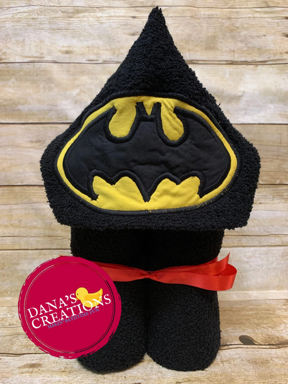 A black hooded towel with the Batman logo on the hood