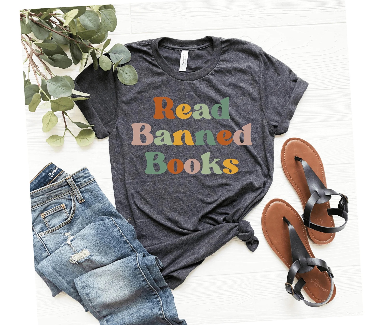 A photo of a grey t-shirt that reads, "Read Banned Books"