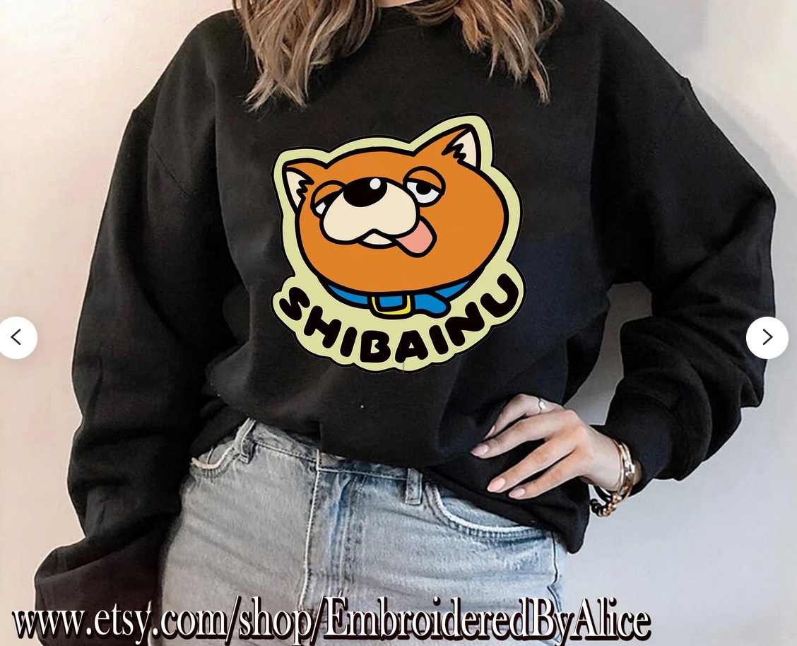 A black sweatshirt with a cartoon shiba inu face