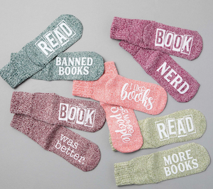 pairs of different colored socks with sayings on the soles like "read more books"