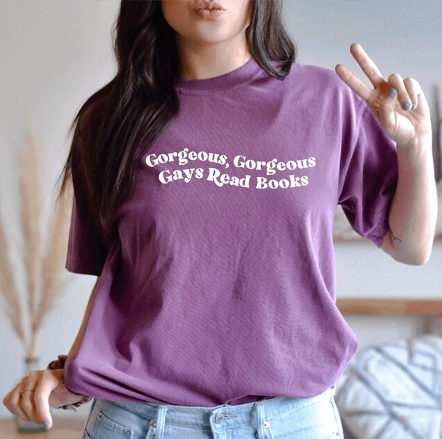 a photo of someone wearing a shirt that reads "Gorgeous, gorgeous gays read books"