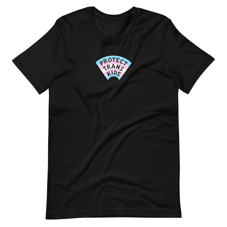 a shirt reading Protect Trans Kids with a trans flag behind the text in an arc