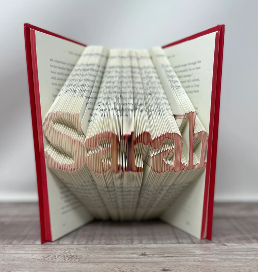 Pages in a book folded to create a name