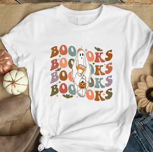 tshirt with graphic design of ghost holding book and pumpkin with "boooooks" text graphic as background