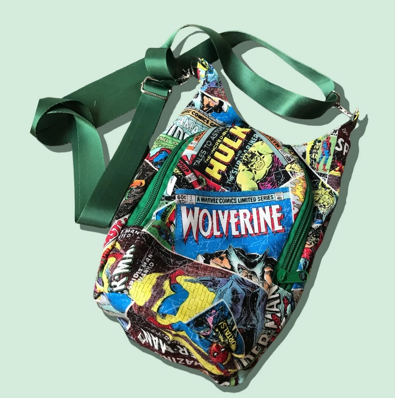 A bag for carrying a water bottle. It is covered in images of Marvel characters