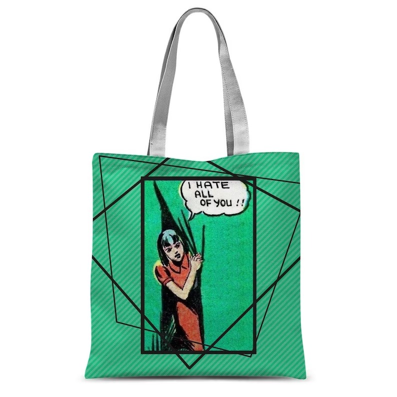 a green tote bag with a comic character saying "I hate all of you"