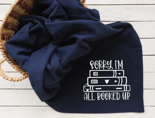 navy blanket with embroidery: "Sorry I'm All Booked Up"