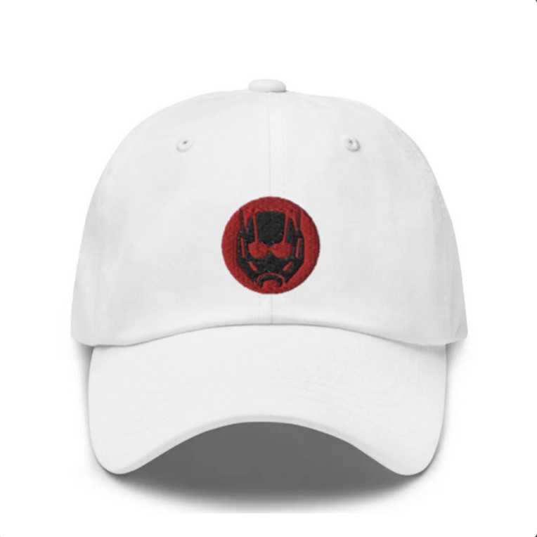 A white baseball cap with a red image of Ant-Man's helmet on the front
