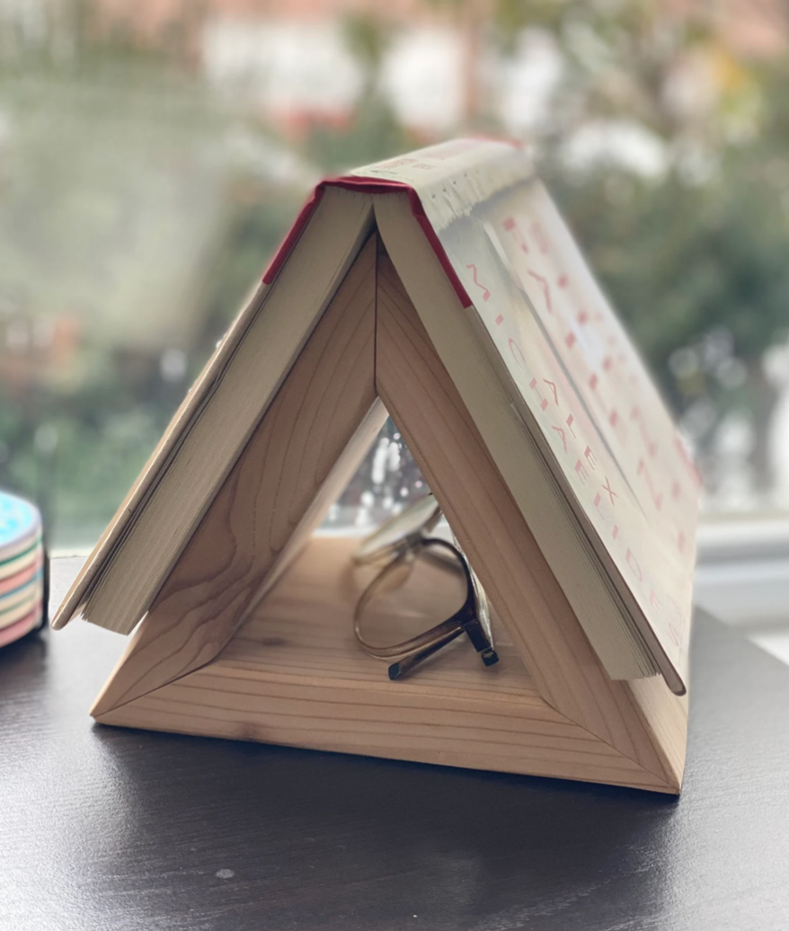 A triangular wooden structure meant to keep a place in a book