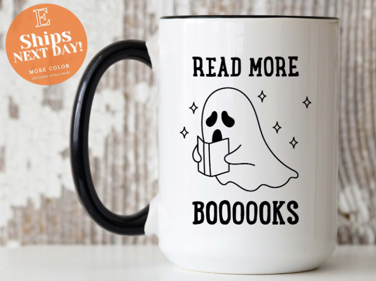 white coffee mug with a cartoon ghost and the words "Read More Boooooooks"
