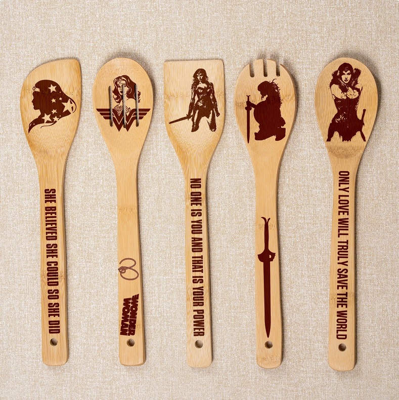 wooden cooking utensils with Wonder Woman-themed designs engraved on them