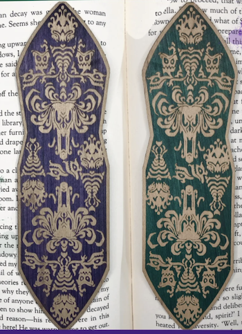 a photo of wooden bookmarks with inspired by Disney's Haunted Mansion illustrations