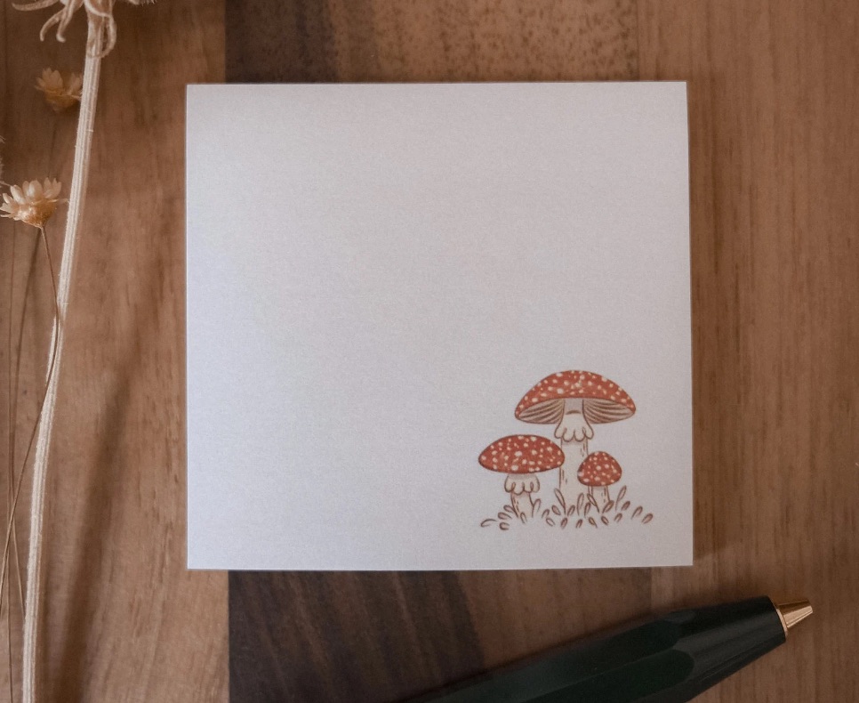 image of a sticky note pad with red mushrooms