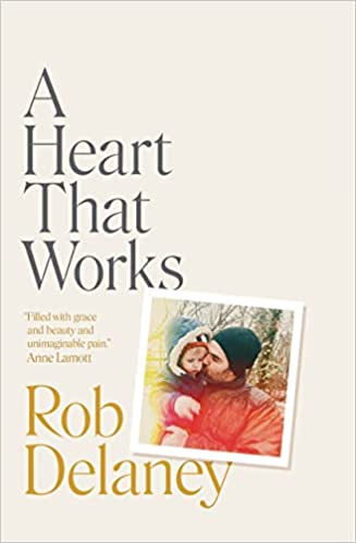 cover of A Heart That Works by Rob Delaney; photo of the author kissing his young son on the cheek
