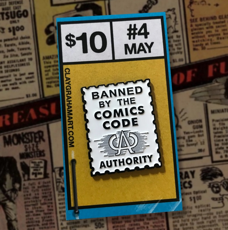 A pin shaped like the old CCA stamp that says "Banned by the Comics Code Authority"