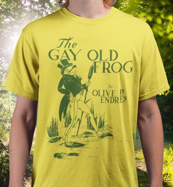 a photo of a T-shirt with the cover of The Gay Old Frog, showing a frog in a top hat