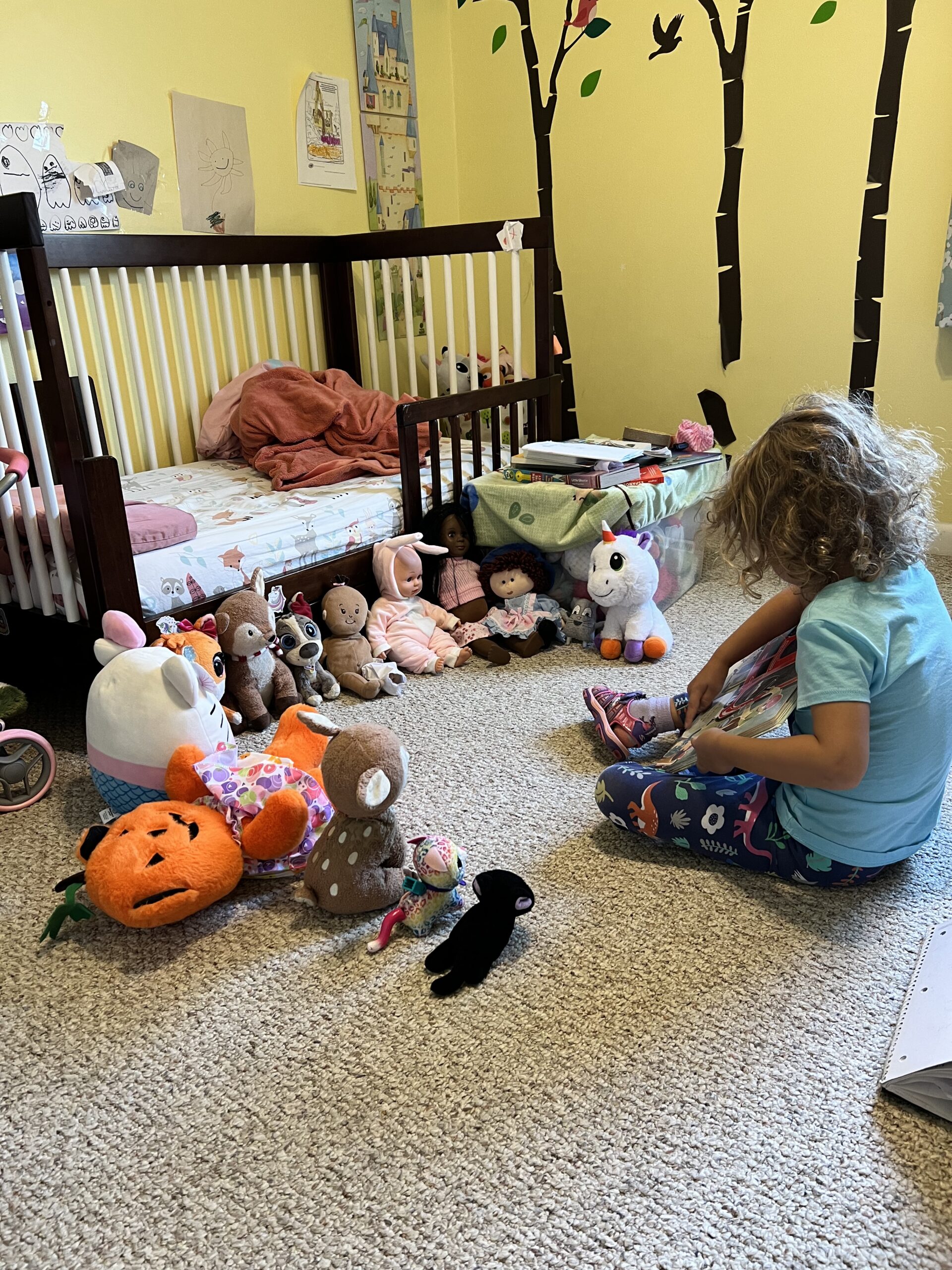 Marian reading to her stuffed animals, the kids are all right