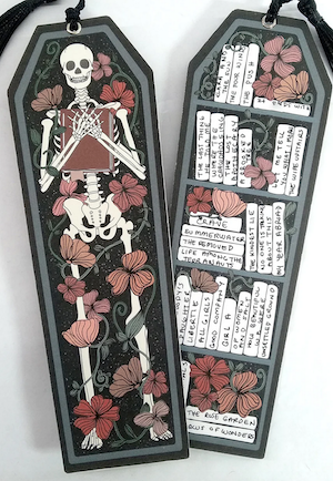 double sided bookmark with skeleton reading on one side and a book tracker on the other shaped like a coffin