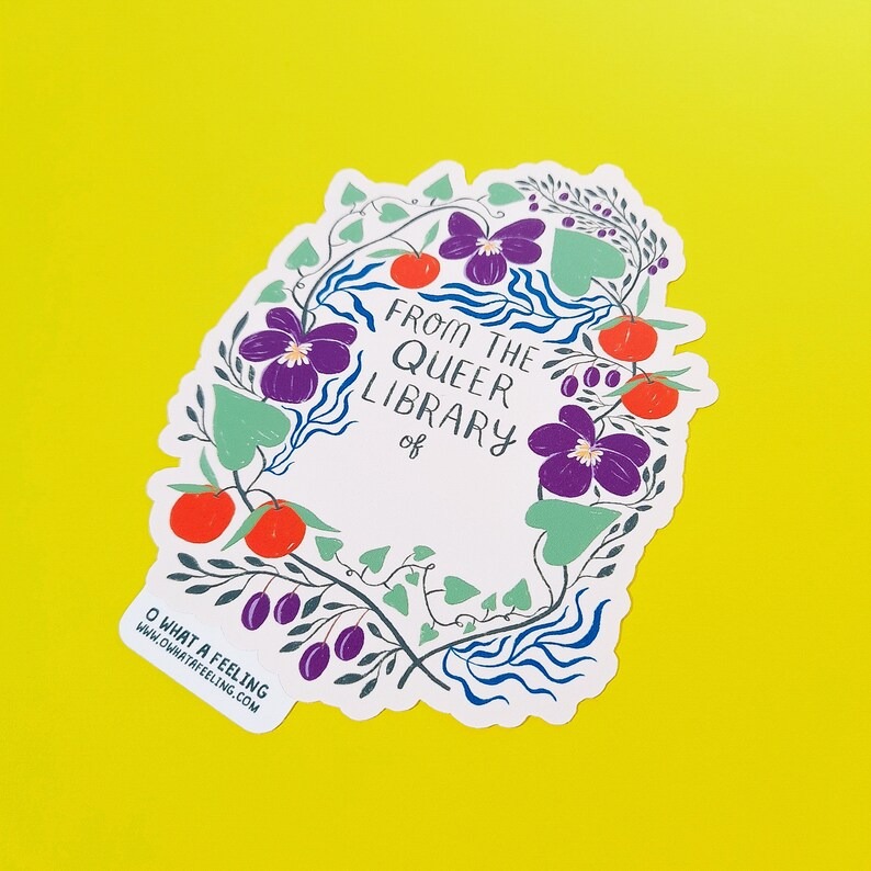 a sticker with a flower border that says From the queer library of...