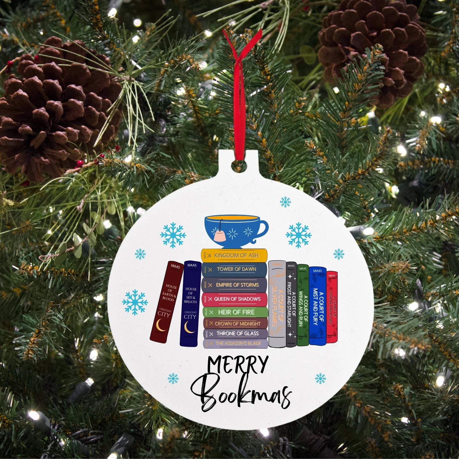 an ornament featuring books and text that says "Merry Bookmas"