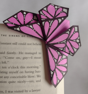 pink paper origami butterfly bookmark page corner