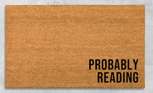 a doormat that says "probaby reading"