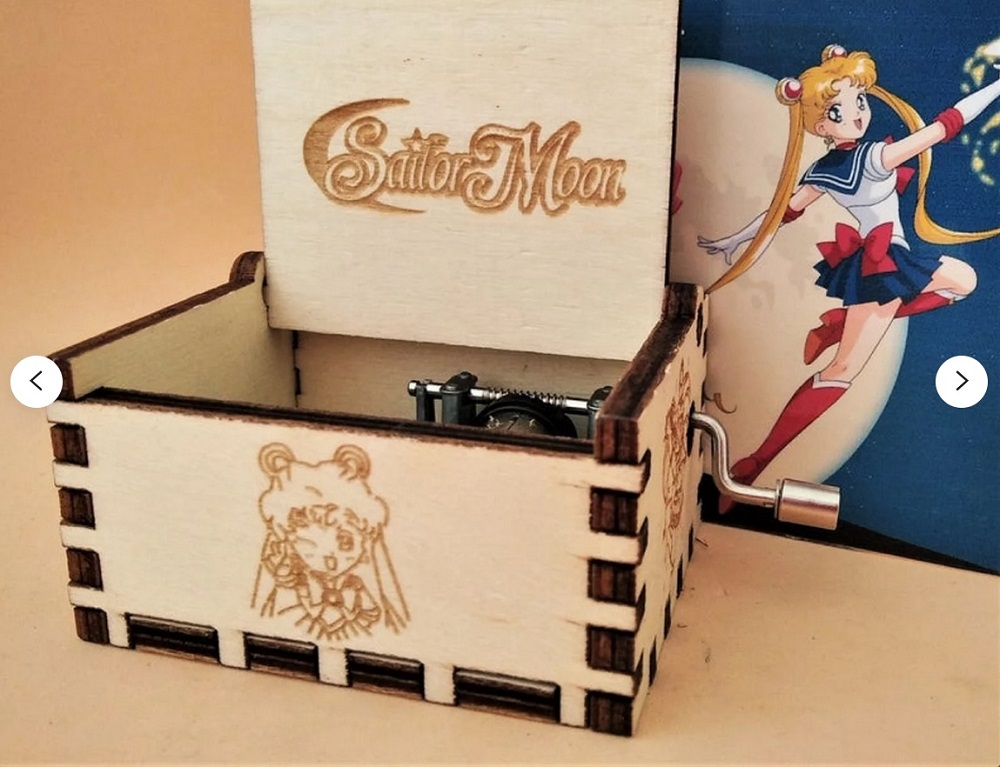 A wooden music box with an image of Sailor Moon burned into it