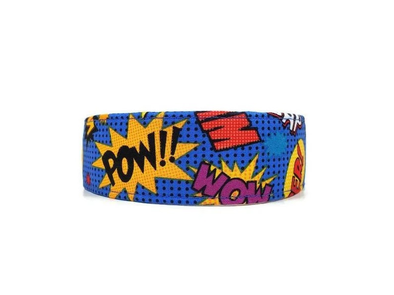 A bright blue pet collar covered in colorful comics onomatopoeias