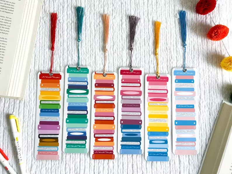 a photo of bookmarks with book stack illustrations in pride flag colors