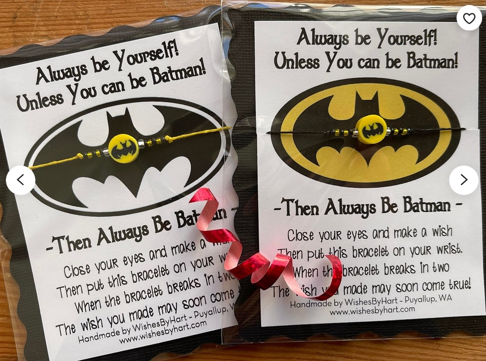 Two thin bracelets with Batman charms in the middle