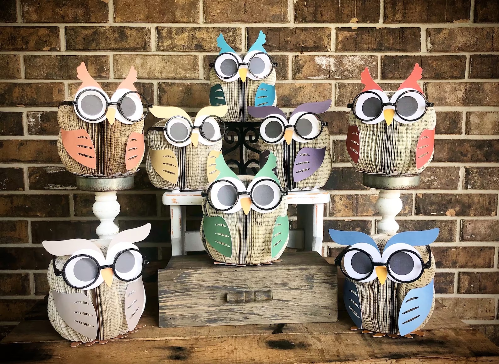 a photo of eight owl sculptures made out of paper