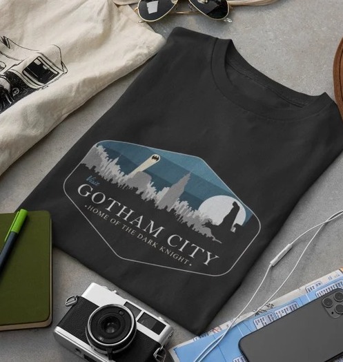A black t-shirt with an image of Gotham City and the words "Gotham City Home of the Dark Knight"
