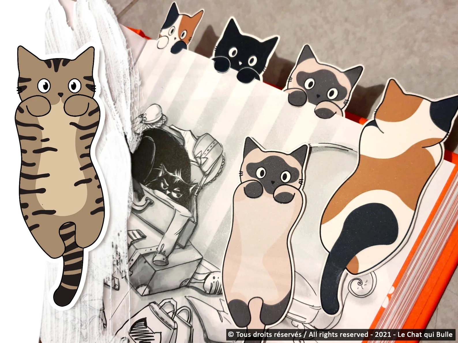 a photo of paper cats in several different color variations. They hang off a book's pages as book marks.