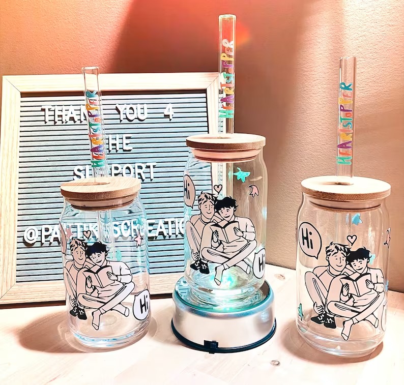a photo of three boba glasses with Heartstopper images
