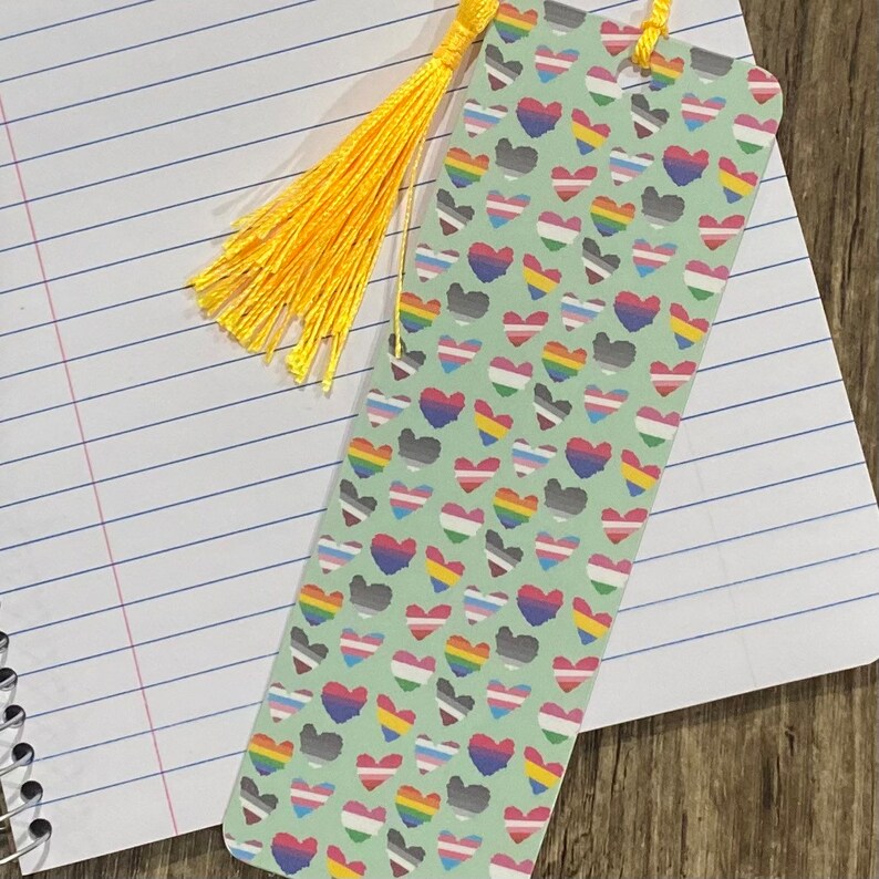 a bookmark with tiny pride flag hearts