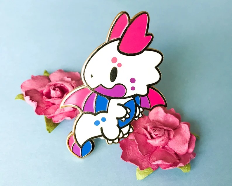 a dragon enamel pin with bisexual flag colors